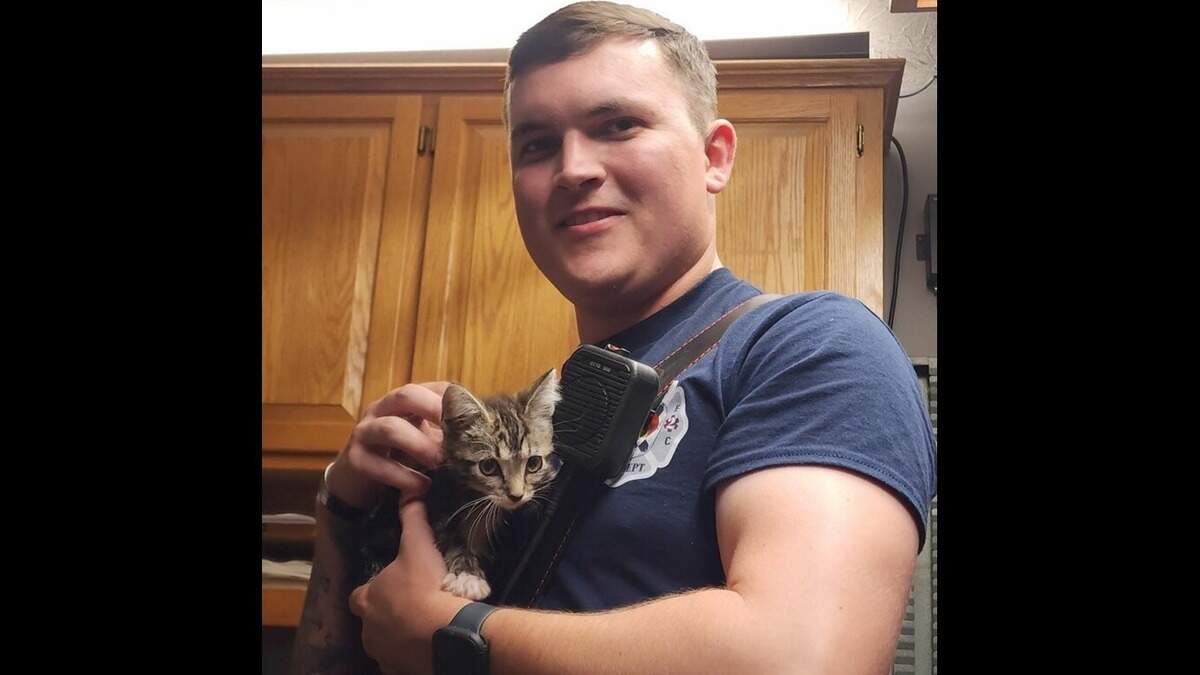 A firefighter poses for a photo with Stormy the kitten, who was rescued from a storm drain at the intersection of Richmond Road and Mt. Tabor Road on July 16, 2024.
