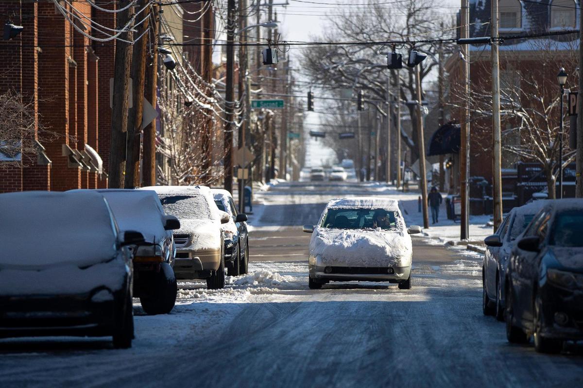A vehicle travels in downtown Lexington, Ky., on Saturday, March 12, 2022. The National Weather Service reported 4.5 inches of snow fell on Friday night.