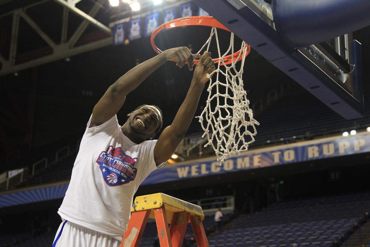 Dominique Hawkins snipped a piece of the net after Madison Central won the 2013 Sweet Sixteen state tournament with a 65-64 win over Ballard.