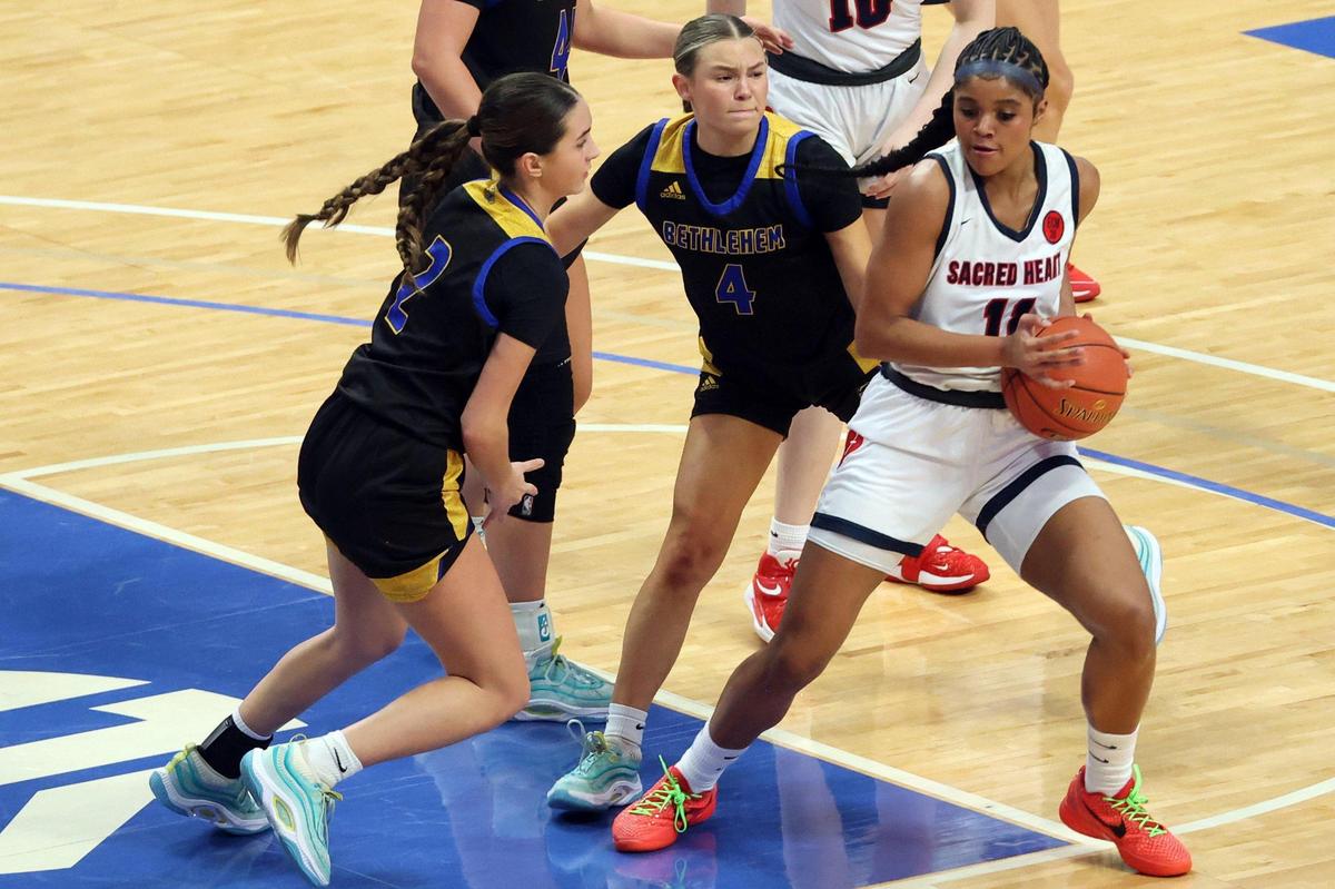 Sacred Heart’s ZaKiyah Johnson, right, looks for an opening against Bethlehem’s Tessa Miles, left and Elizabeth Mason during the Girls’ Sweet 16 quarterfinals at Rupp Arena on Friday. Johnson finished with 21 points, five rebounds, five assists and four blocks.