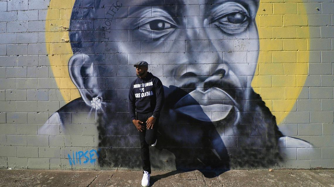 Social activist and hip-hop artist Richard Spaulding, better known through his alias Devine Carama, stands at a mural of rapper Nipsey Hussle painted on the side of Shopper’s Choice Market on Georgetown Street. He is raising awareness for Breonna Taylor and the systemic racism with his record and songs, including his “16 Bars for Breonna Taylor” project posted to his SoundCloud. October 13, 2020.