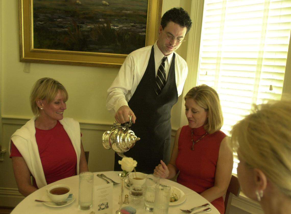 Rob Hawkins served tea to, from left, Nelia Padgett, Shar Montgomery, and Sheila Hancock at Greentree Tearoom where only tea, no coffee, was served, in May 2003.