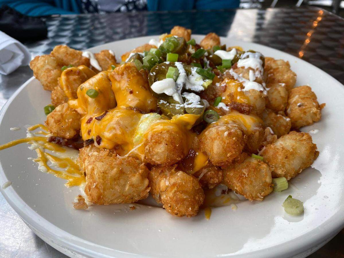 Loaded Brown Barrels from the Brown Barrel and Blind Harry’s in downtown Midway features tater tots topped with bacon, jalapenos, Monterey jack cheese, scallions and smoked cilantro sour cream.