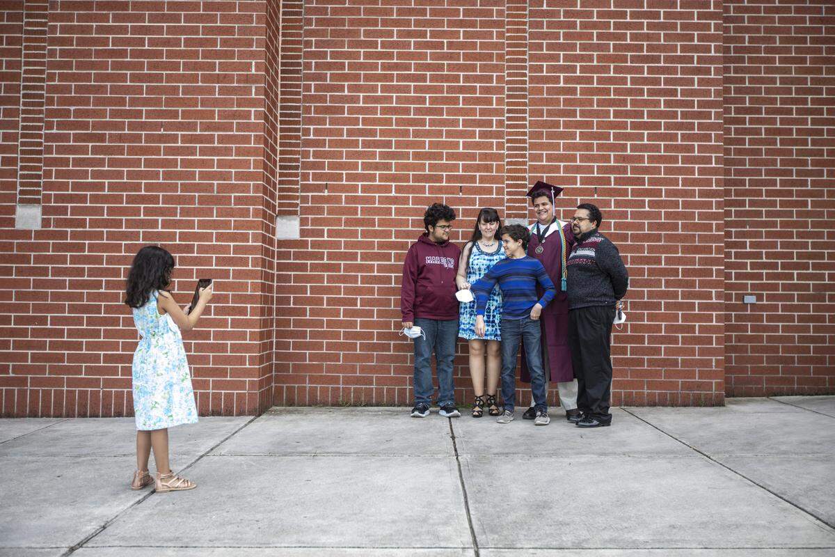 Hannah Wright takes a photo of her family, Andrew, from left, Lisa, Matthew, Joel and Kolan, at Joel’s drive-thru graduation May 20 at Pulaski County High School.
