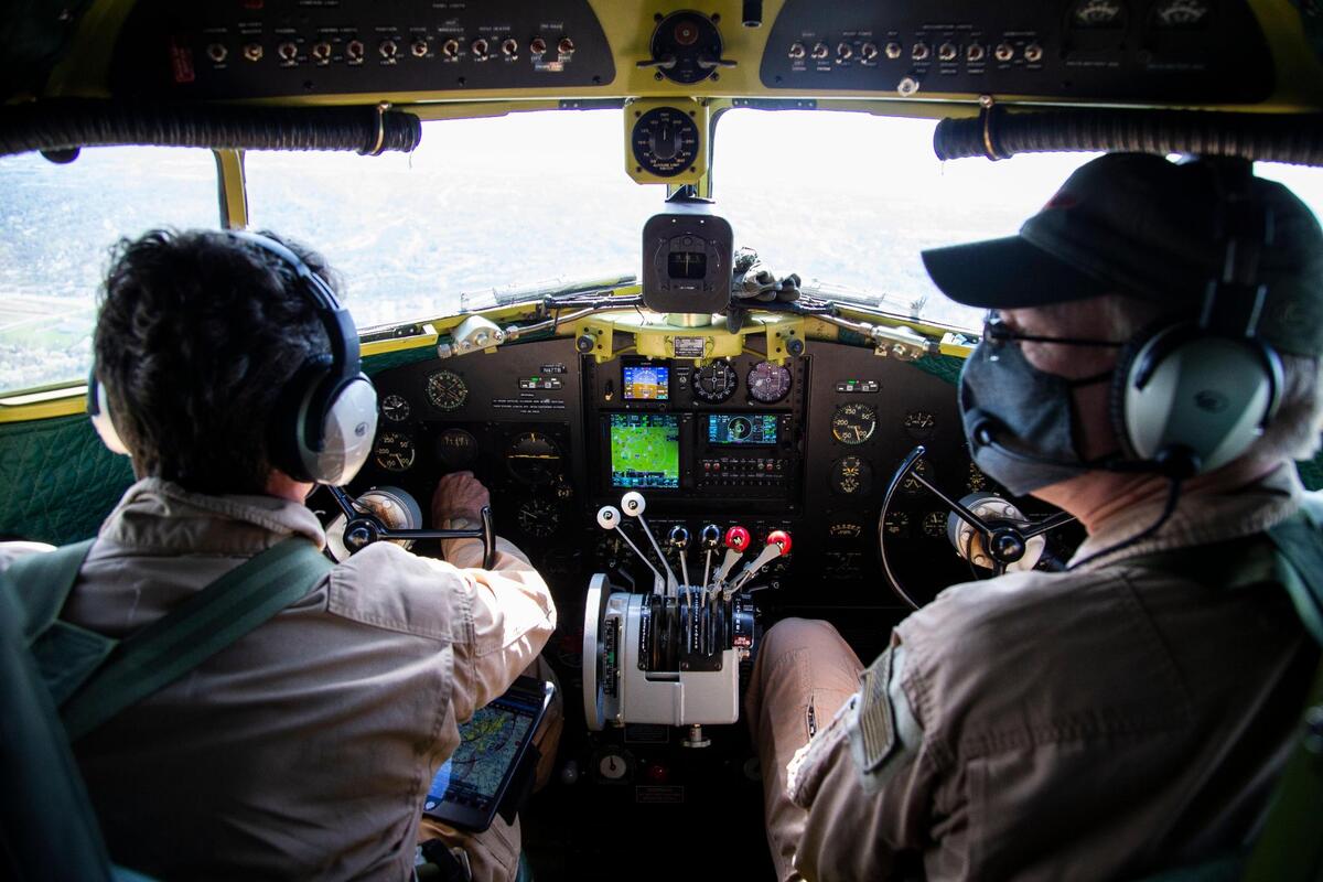 Pilot John Cotter and co-pilot John Biixby fly the C-47 “That’s All Brother” above central Kentucky after taking off from the Blue Grass Airport Aviation Museum with passengers in Lexington, Ky., Friday, April 9, 2021.