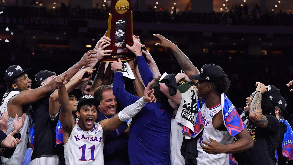 The Kansas Jayhawks raise the NCAA championship trophy after beating North Carolina, 72-69 Monday night in New Orleans.