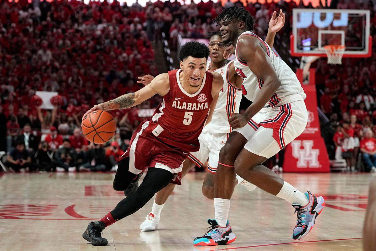 Alabama’s Jahvon Quinerly (5) drives past Houston’s Marcus Sasser (0) and Jarace Walker (25) for a basket last Saturday. The Crimson Tide’s 9-1 start has included wins over the Cougars and North Carolina, who were both ranked No. 1 at the time.