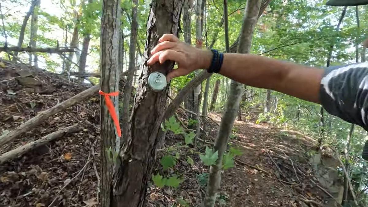A frame grab from Fred and Shelia McCoy’s YouTube page points out a survey marker on a tree. The video posted to the couple’s YouTube page shows survey markers on the ground and trees. Fred, who has a law enforcement background, said he thinks police used these to help determine exactly where Couch was shooting from.