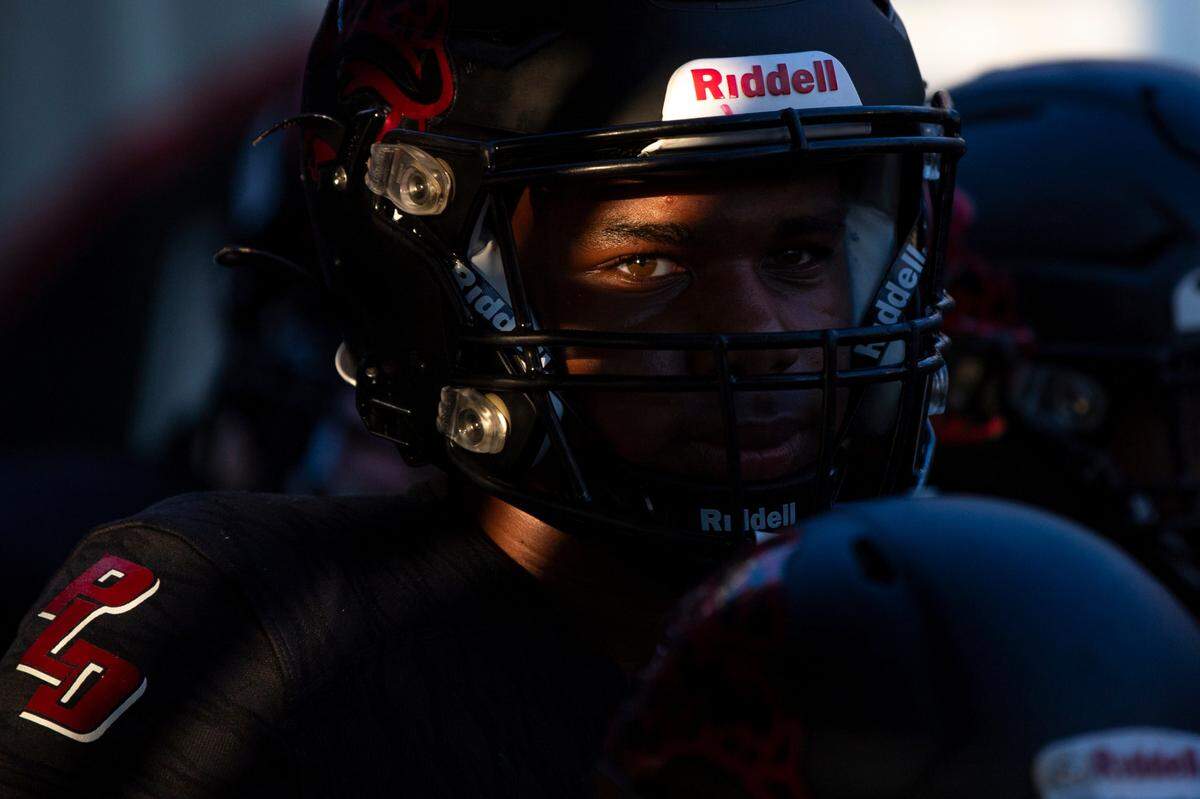 Dunbar football players ready their game faces in preparation of their game against Tates Creek as the sun sets at Paul Laurence Dunbar in Lexington, Ky, Friday, September 29, 2023. Dunbar finished the season 3-8.