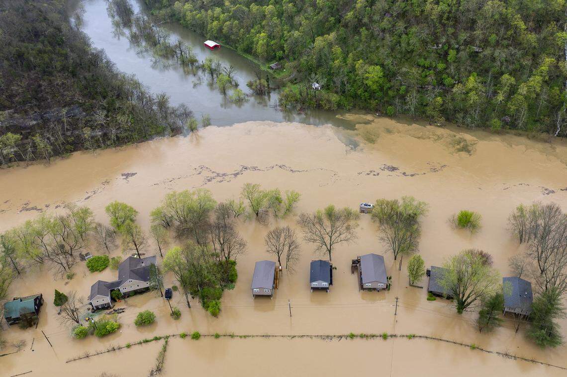 The Kentucky River surrounds homes on Dix Drive near High Bridge in Jessamine County on Saturday, April 5, 2025.