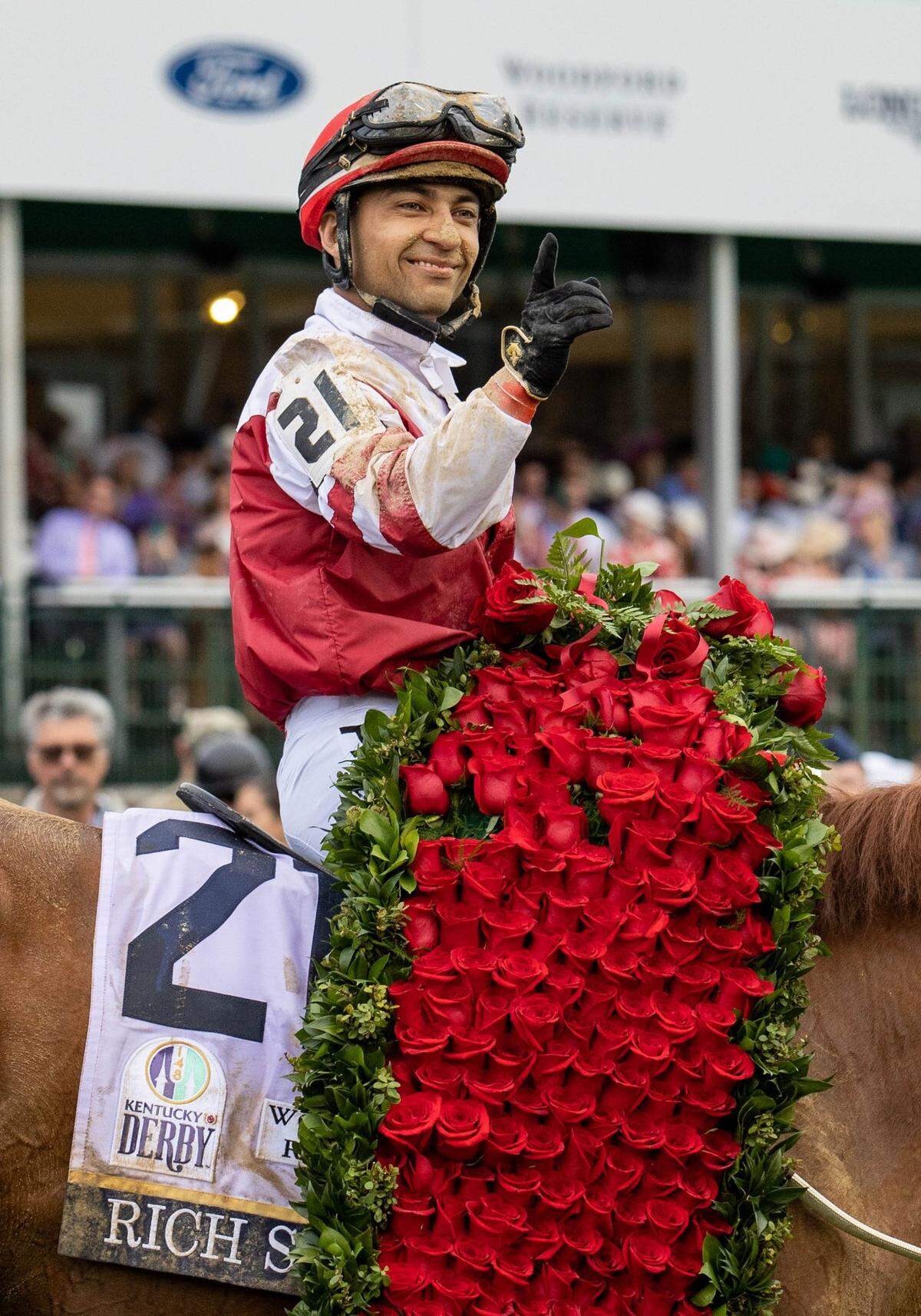 Jockey Sonny Leon, riding Rich Strike, parades around with the garland of roses after winning the 148th Kentucky Derby at Churchill Downs on May 7.