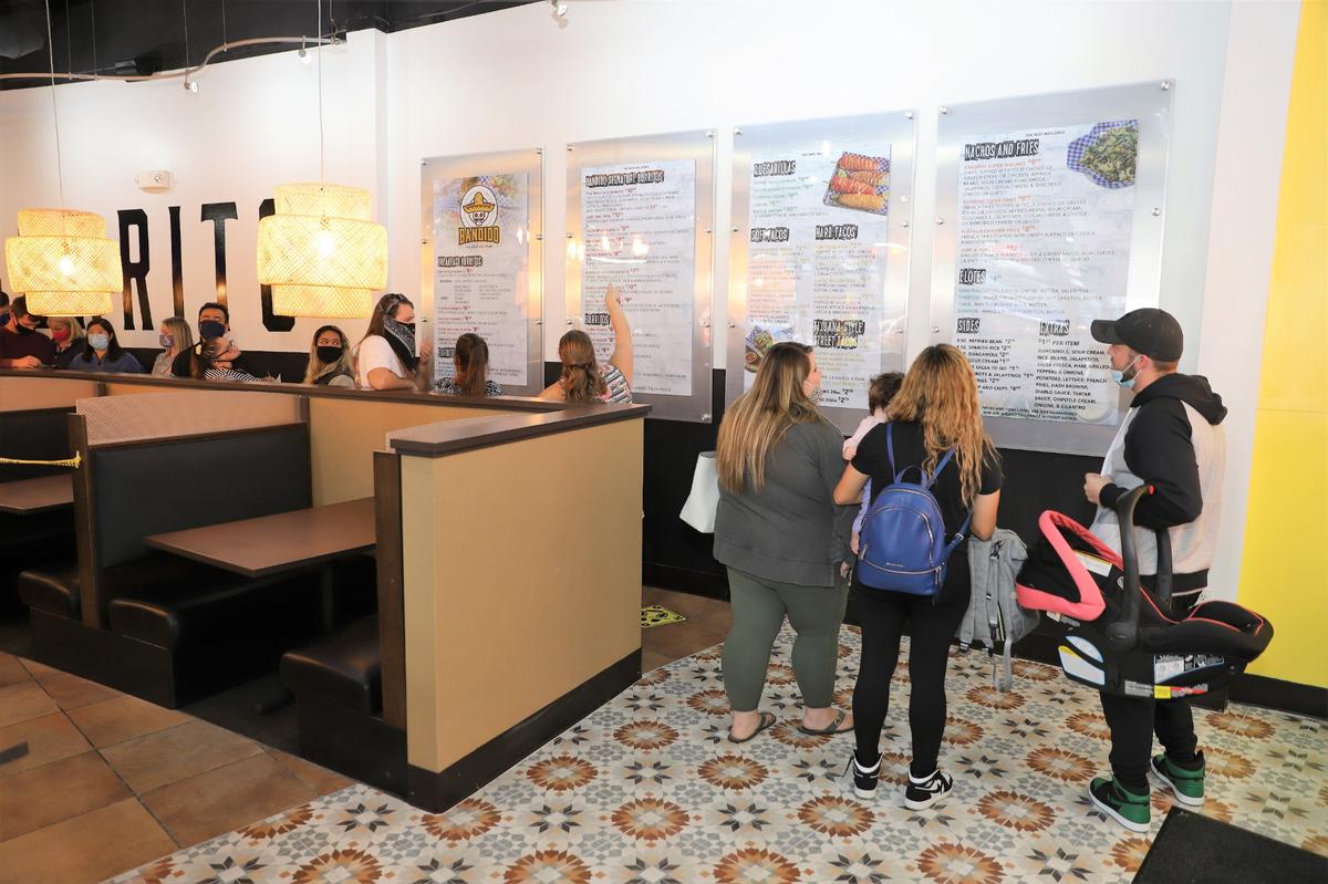 People waited in line to order food during the Friends and Family night soft opening at Bandido Taqueria Mexicana, Lexington’s first Southern California-style taqueria, on Wednesday evening, Sept. 23, 2020. The restaurant opens to the public on Sept. 25.