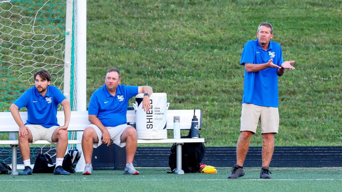 Lexington Catholic boys’ soccer head coach Todd Bretz, right, has won more than 500 career games, as has his girls’ counterpart at LexCath, Terry Quigley. With Bretz are assistant coaches Jack Hayden, left, and Jeff Stone.