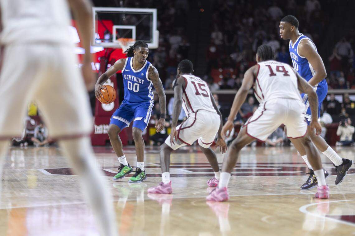 Kentucky guard Otega Oweh (00) looks to move the ball as Oklahoma guard Duke Miles (15) defends during Wednesday’s game at Lloyd Noble Center in Norman, Okla.