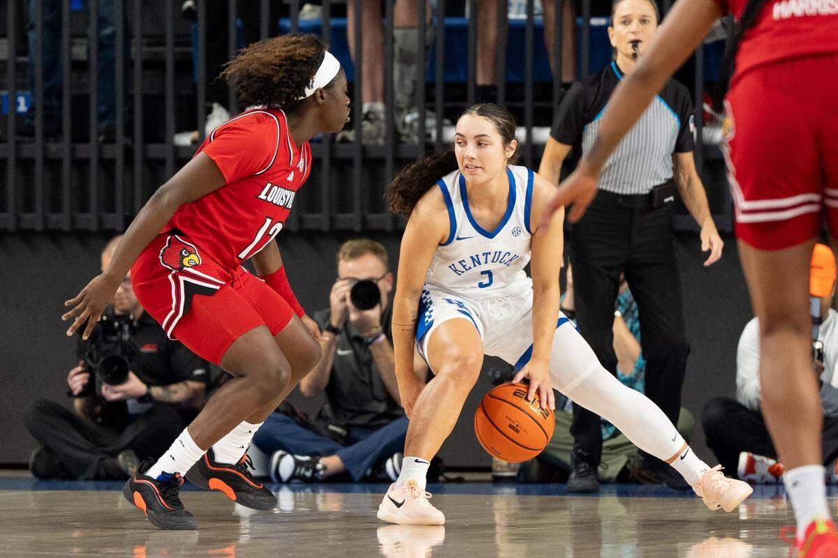 Kentucky Wildcats guard Georgia Amoore (3) defends the ball against Louisville Cardinals guard Ja'Leah Williams (12) during their game on Saturday, Nov. 16, 2024 at Memorial Coliseum in Lexington, Ky.