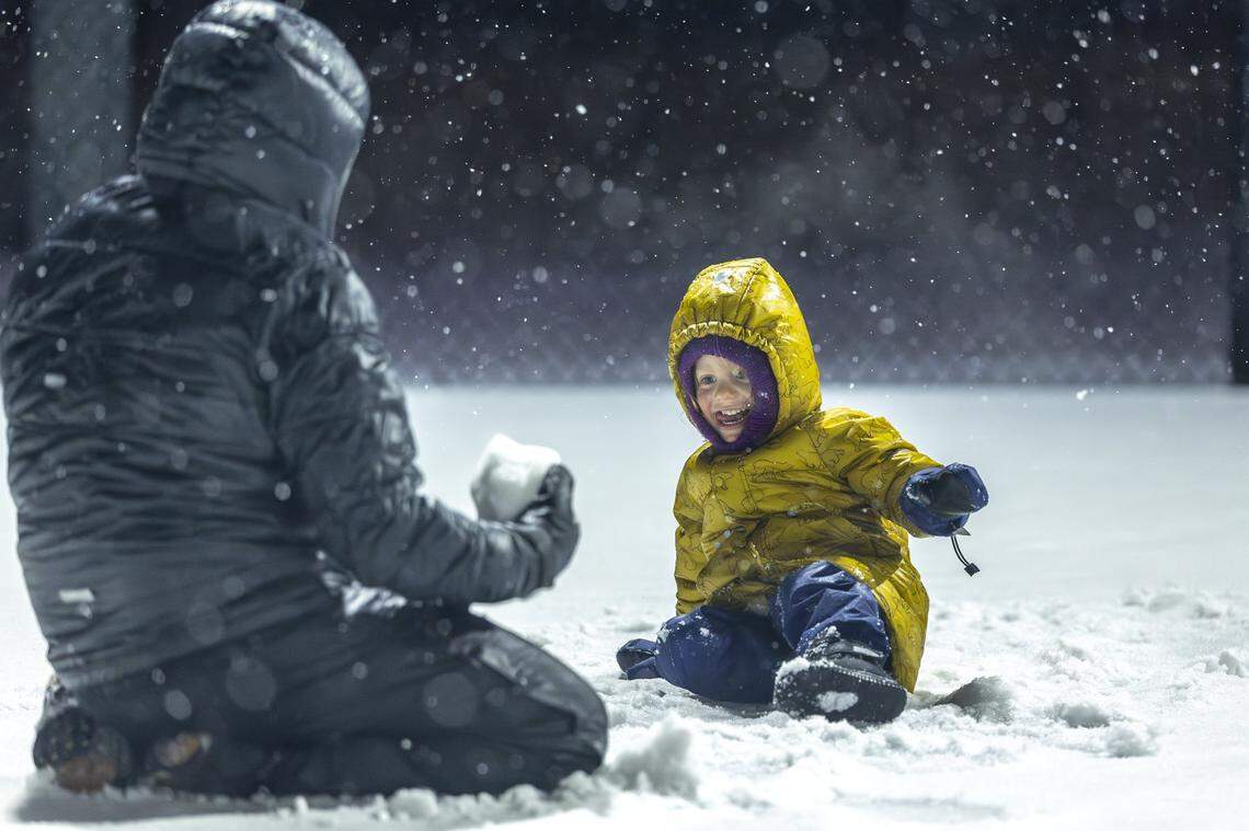 Ayal Brokman, 3, smiles as his dad, Aviv, makes a snow ball at Woodland Park in Lexington, Ky., on Tuesday, Feb. 3, 2026.