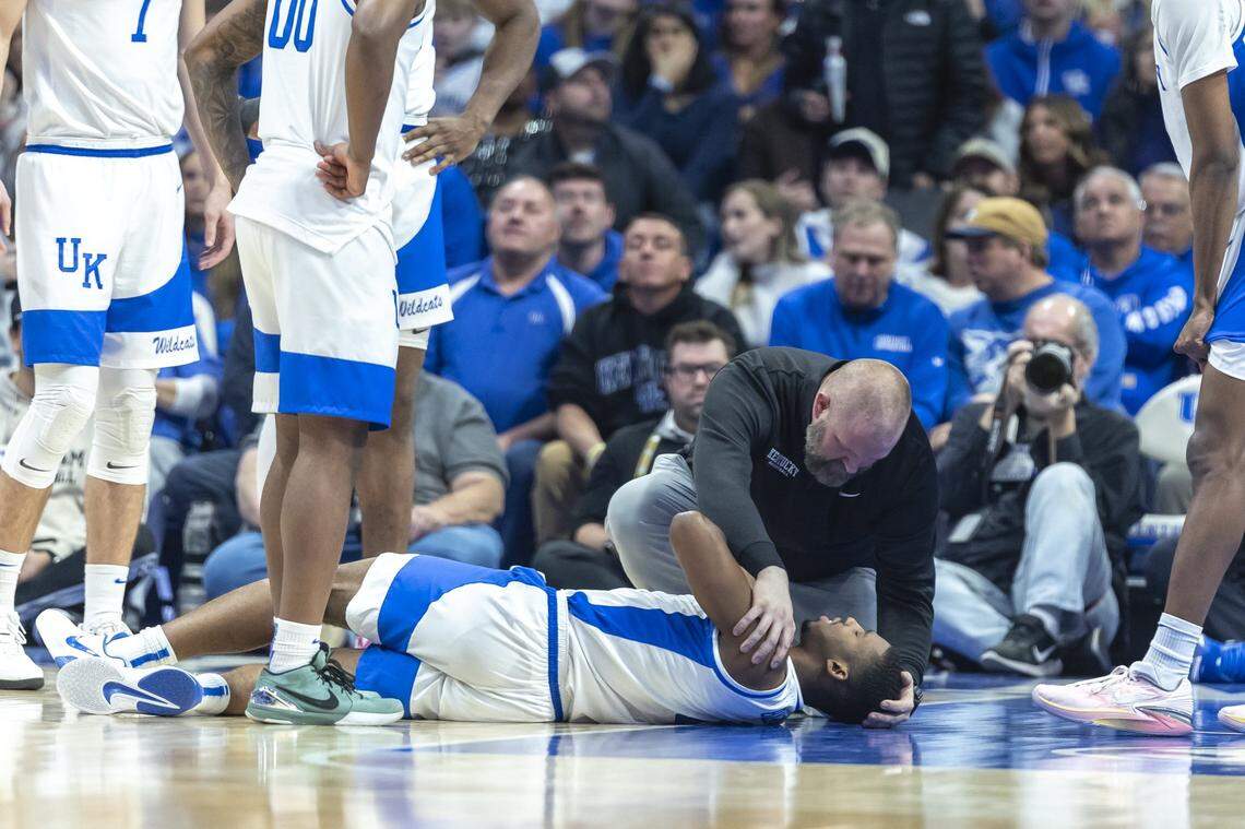 UK senior athletic trainer Brandon Wells tends to Kentucky guard Lamont Butler during a game against Texas A&M on Jan. 14.