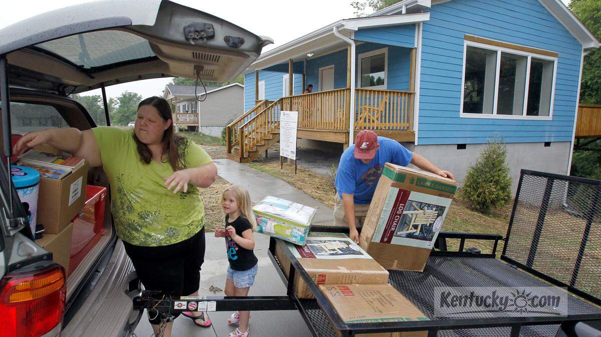  Marlena and John Hoover, with help from their 4-year-old daughter Jaidyn, moved into their new Habitat For Humanity house, 404 Brown Street in Berea, Ky., Friday, July 13, 2012. Habitat has just finished the house which is the first Passive House it's ever built in Kentucky. The Hoovers, along with daughters Madison and Jaidyn, were moving in today. The house has several passive features to reduce energy including double thick walls, highly efficient windows, and extra insulation. 
Photo by Charles Bertram | Staff