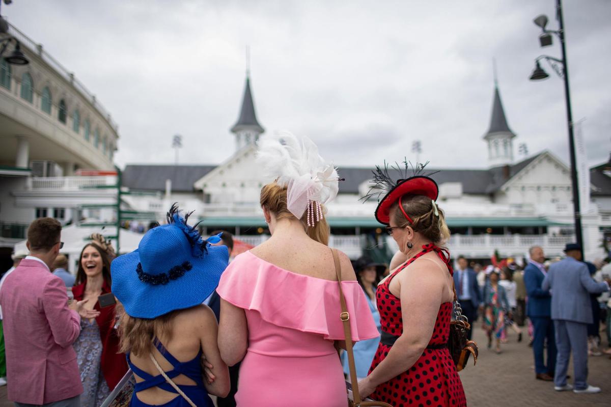 Fans pause to take photos after entering the front gates before the 148th running of the Kentucky Derby at Churchill Downs in Louisville, Ky., Saturday, May 7, 2022.