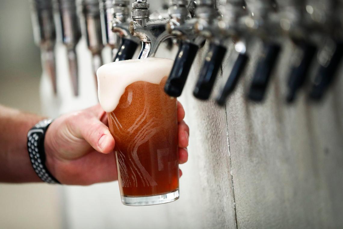 Rock House Brewing co-owner Billy Hacker, of Lexington, Ky., pours a Wildcat Groupie, a cream ale infused with blueberry in the brewing facility at Rock House in Lexington, Friday, Feb. 14, 2020. The brewery is being sold.