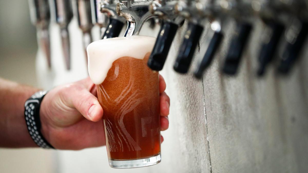 Rock House Brewing co-owner Billy Hacker, of Lexington, Ky., pours a Wildcat Groupie, a cream ale infused with blueberry in the brewing facility at Rock House in Lexington, Friday, Feb. 14, 2020.