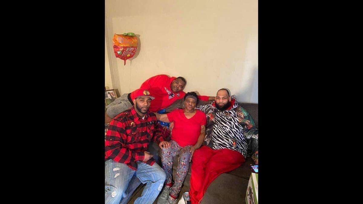 Brandon Walker (right) poses for a photo with his mother and two brothers.