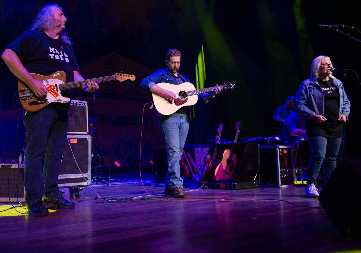 Tyler Childers, center, performs with David Prince, left, and Teresa Prince Friday, Feb. 7, 2020, at the Ryman Auditorium in Nashville, Tenn. The two Lawrence County, Ky. school teachers have known Childers since he was a child and he wanted to honor them with a Ryman Audtiorium performance. They performed a Teresa Prince original called That Thing You said.