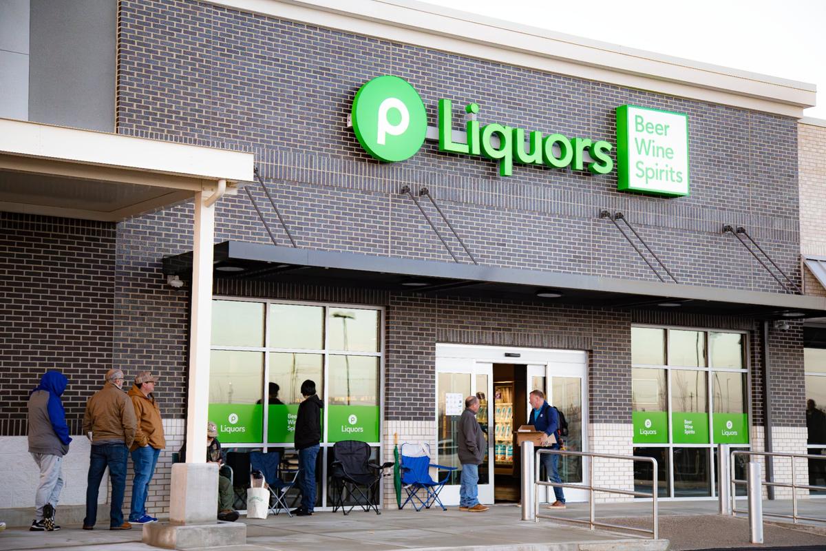New customers stand in a line waiting for the Publix Liquors open hours on March 5, 2025 in Lexington, Ky.