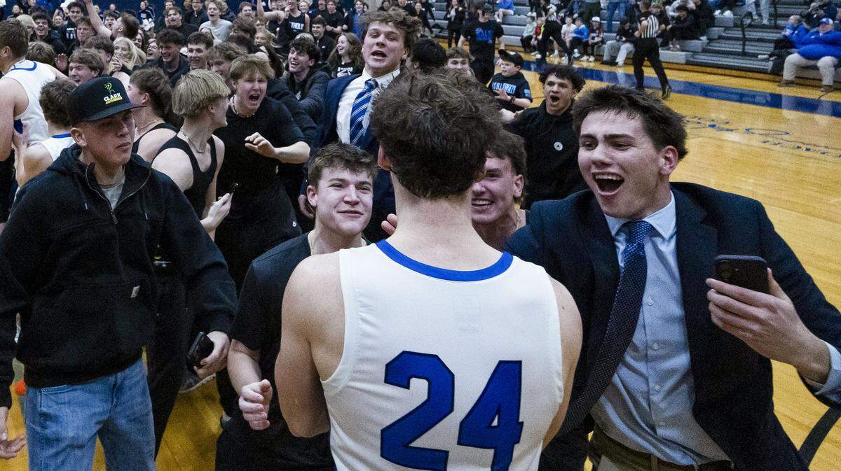 Lexington Catholic’s Max Meagher (24) celebrates with fellow students after the Knight’s 60-56 win over the Madison Central on Monday at Lexington Catholic High School.