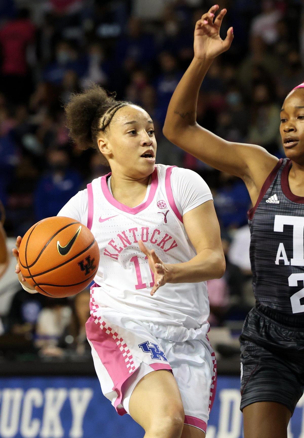 Kentucky’s Jada Walker (11) looks for an opening against Texas A&M’s Qadashah Hoppie on Sunday. Walker scored nine points in the first quarter but later left the game with an injury.