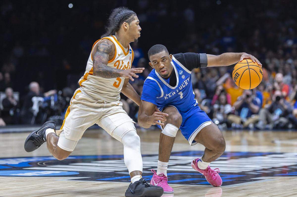 Kentucky guard Lamont Butler, right, drives the ball as Tennessee guard Zakai Zeigler defends during Friday’s Sweet 16 game at Lucas Oil Stadium in Indianapolis. Butler played four seasons at San Diego State before transferring to play his fifth and final season at UK.