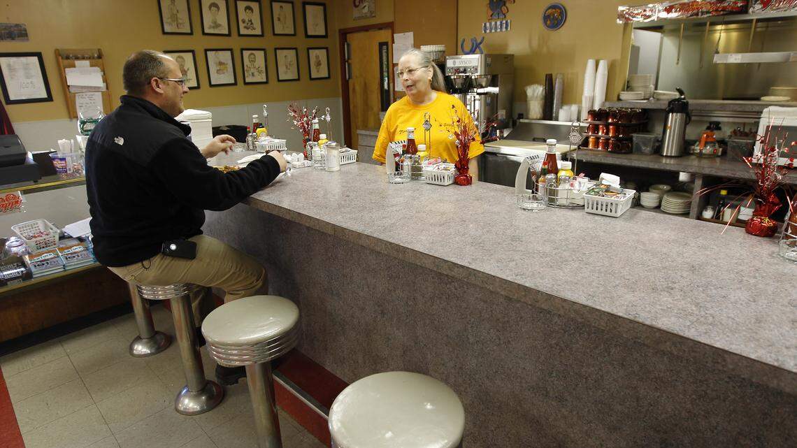 Dining room manager Joyce Seals served customer Brad Weaver his breakfast at Sam's Restaurant on U.S. 25 near Georgetown, Ky., Friday, February 11, 2011. The restaurant, which is is located in northern Scott County near the Fayette County line, has new owners. Brad works right down the road from Sam's and stops in every morning for breakfast. Brad said "since I'm not married and don't have anyone to cook my breakfast, I rely on them".  Charles Bertram | Staff