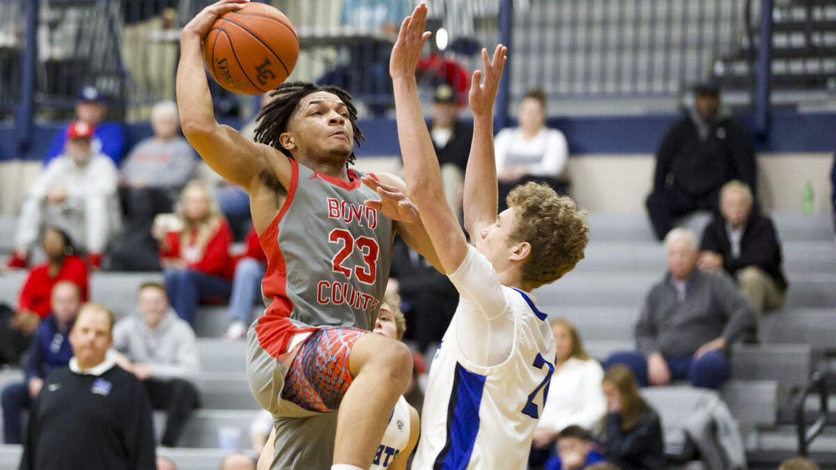 Boyd County’s Malachi Payne (23) drove to the basket against Lexington Catholic’s Will Wheeler in the semifinals of the White, Greer & Maggard Holiday Classic at Lexington Catholic High School on Monday.
