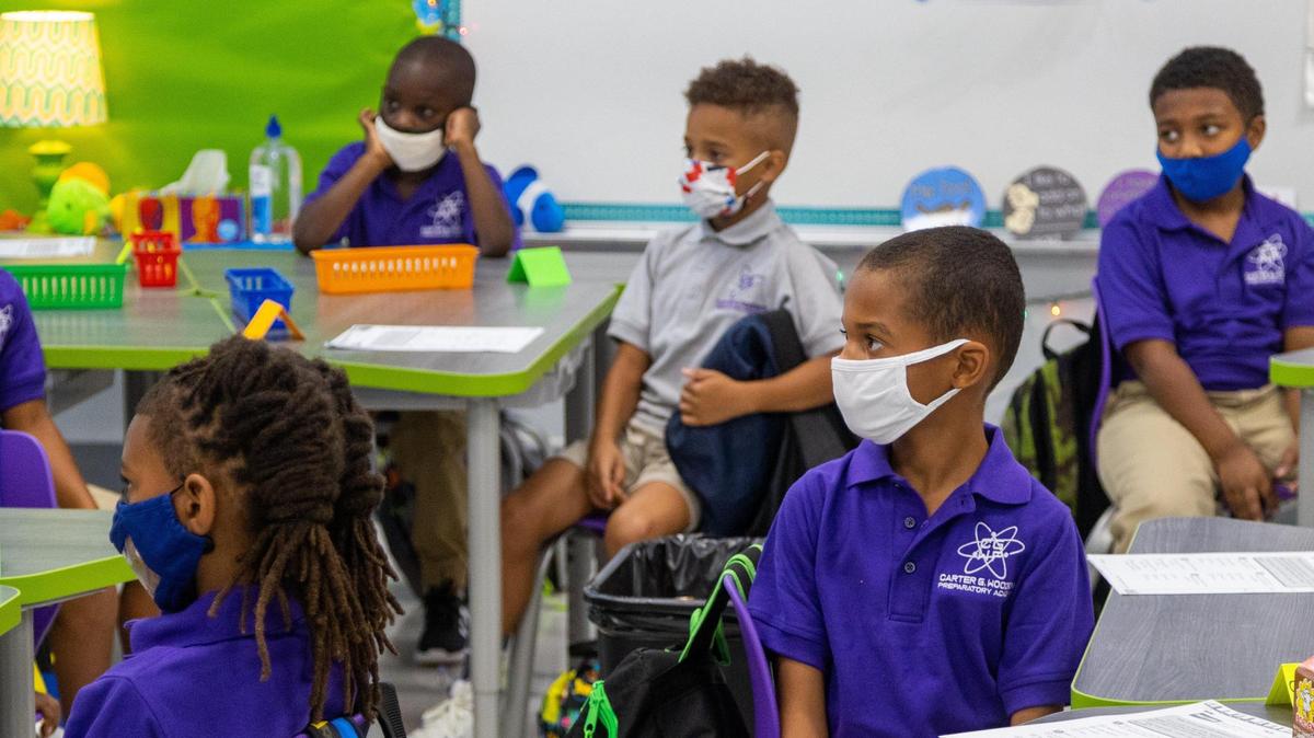 2nd grade students of Carter G Woodson Preparatory Academy listen intently to their teacher on classroom etiquette for their first day of school, August 11, 2021.