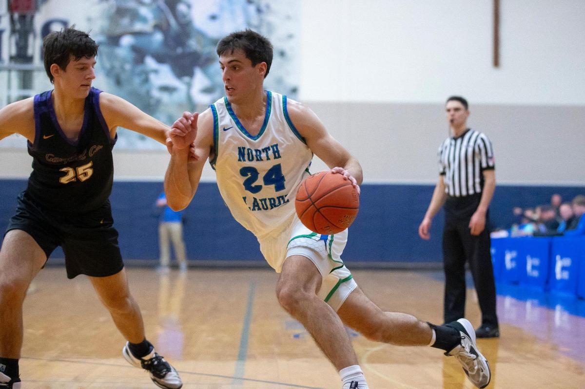 North Laurel’s Ryan Davidson (24) drives against Campbell County’s Connor Weinel (25) during the opening round of the White, Greer & Maggard Holiday Classic at Lexington Catholic High School on Tuesday. Davidson led the Jaguars to the win with 28 points.