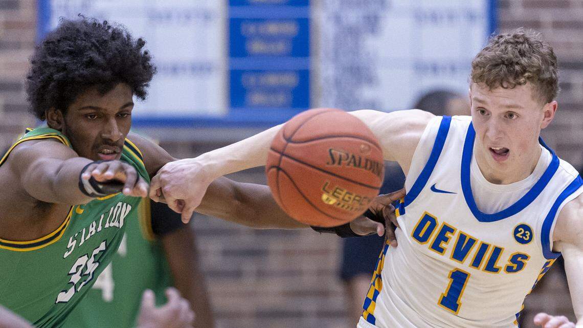 Henry Clay's Jackson Stephan (1) and Bryan Station's Taeshawn Adams (35) chase for a loose ball during the Blue Devil's 70-67 overtime win over Bryan Station in a KHSAA basketball game, Friday, Feb. 13, 2026 at Henry Clay High School in Lexington, Ky.