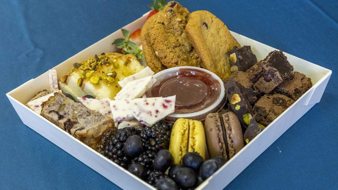 The Sweet & Grazey charcuterie board (Grab & Graze size; $12) from Graze Craze. The dessert tray features gourmet chocolates, baked goods, sweets, fruit and a jelly for dipping. Photographed Wednesday, Dec. 10, 2025, in Lexington, Ky.