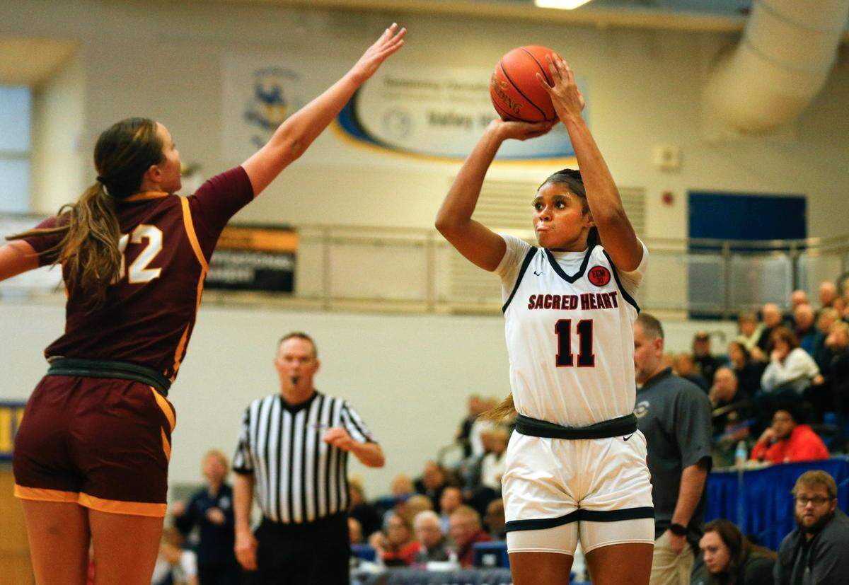 Sacred Heart's ZaKiyah Johnson makes the shot against Cooper's Liz Freihofer in the 2024 Republic Bank Girls LIT Semi Final Saturday morning. Jan. 27, 2024