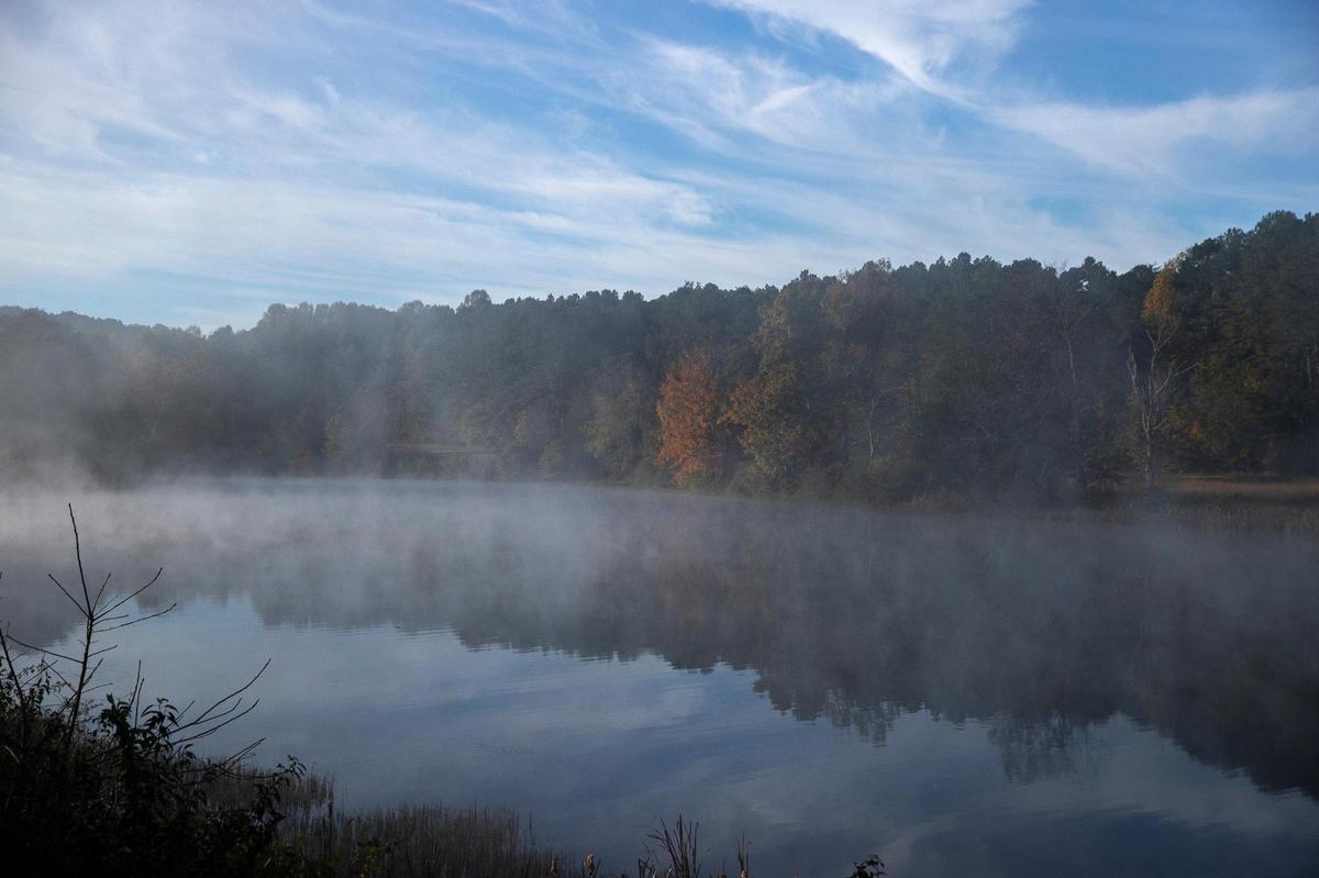 Fog rises from Lake Nevin at the Bernheim Arboretum and Research Forest in Clermont, Ky., on Wednesday, Oct. 27, 2021. Bernheim is open year-round except, Thanksgiving, Christmas, and New Year’s days
