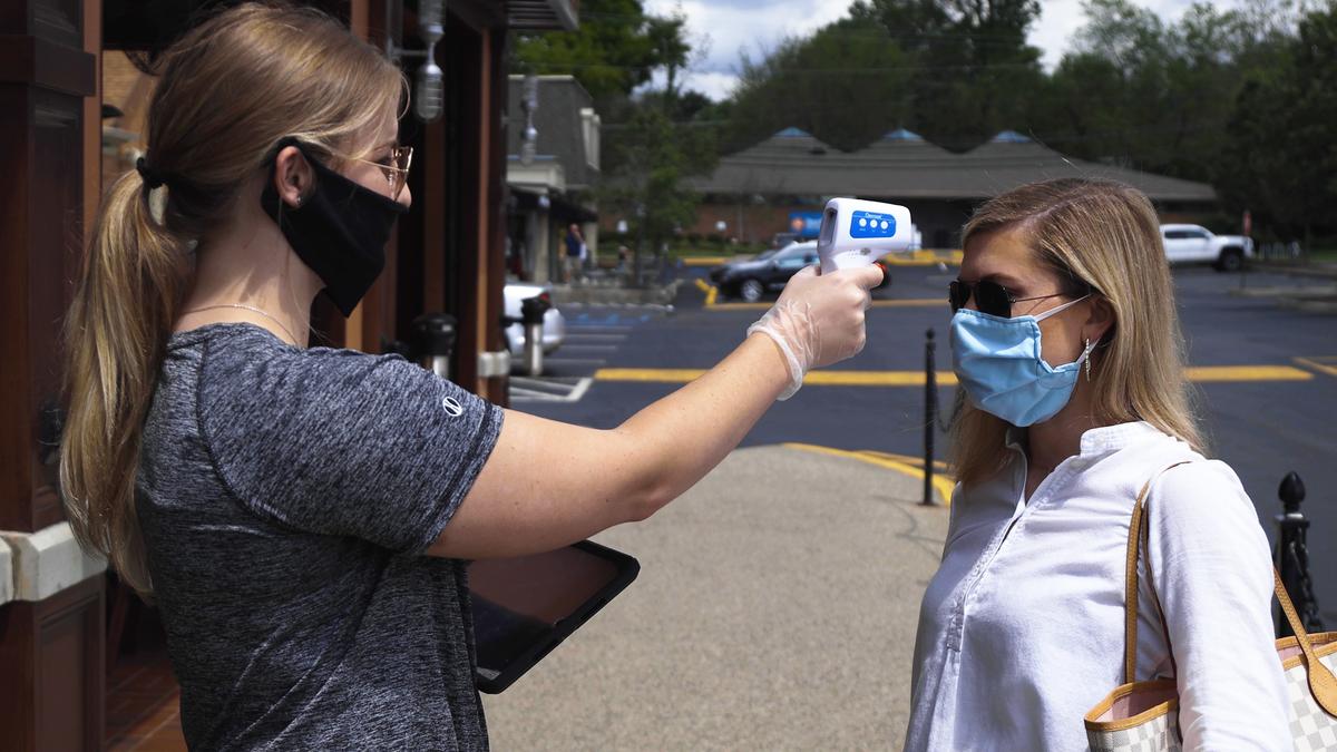 Lauren Coleman had her temperature checked by a Drake’s employee before entering the restaurant on Friday, the first day Kentucky restaurants were allowed to reopen their dining rooms. Drake’s and all other BHG restaurants are requiring all staff members and dine-in customers to have their temperature read and confirmed to be below 100 degrees before entering their restaurants.