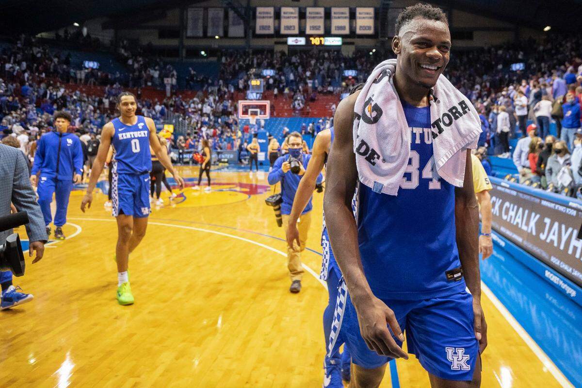 Oscar Tshiebwe (34), Lance Ware (0) and the Wildcats were all smiles as they left the court following Saturday night’s win at Kansas. The team talked Tuesday about staying motivated to improve after such a dominating victory.