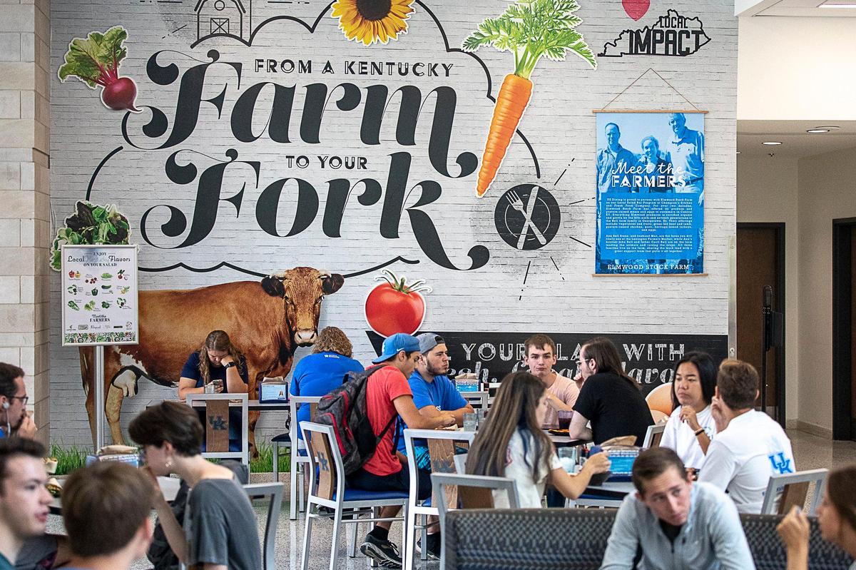 Diners eat lunch at The 90 on the University of Kentucky campus. The sign on the wall highlights Aramark’s efforts to source local produce and meats.