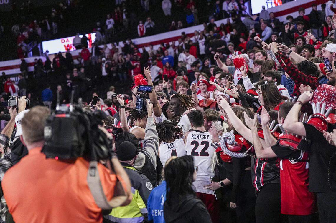 Jan 7, 2025; Athens, Georgia, USA; Georgia Bulldogs players jump into the stands to interact with fans after Georgia defeated the Kentucky Wildcats at Stegeman Coliseum. Mandatory Credit: Dale Zanine-Imagn Images