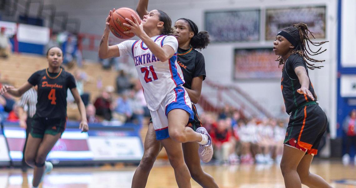 Madison Central’s Nataya Strader (21) shoots the ball in front of Frederick Douglass’ Jaelee Knowles (23) during the Broncos’ 64-58 win at Madison Central High School in Richmond on Feb. 7.