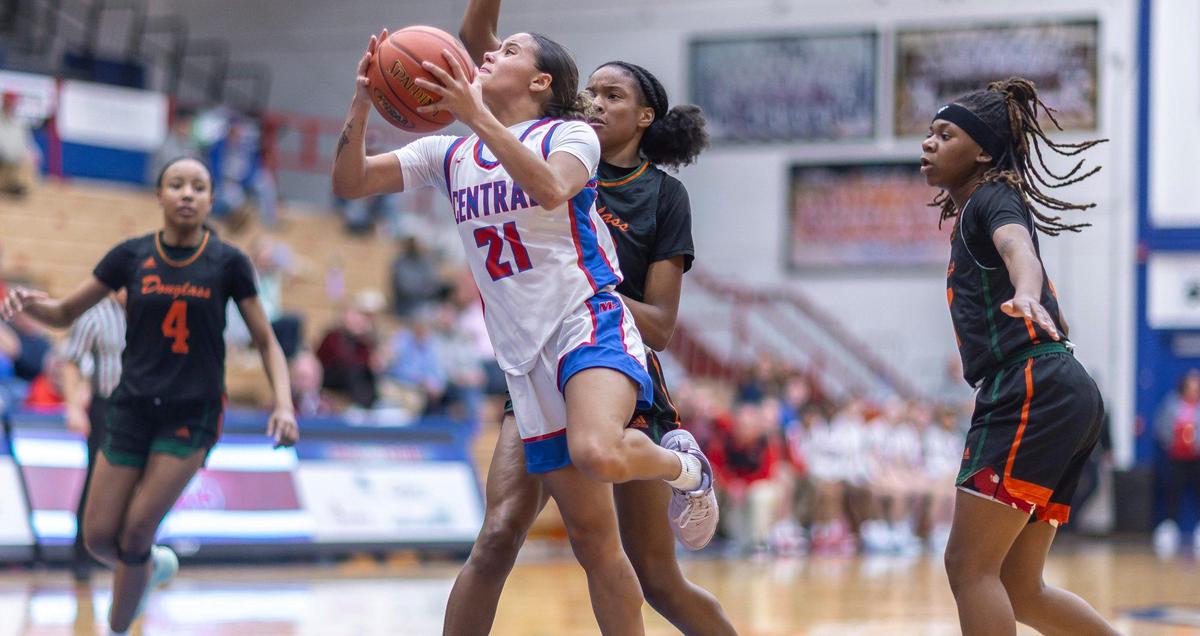 Madison Central’s Nataya Strader (21) shoots in front of Frederick Douglass’ Jaelee Knowles (23) during the Broncos’ 64-58 win at Madison Central High School in Richmond on Feb. 7.