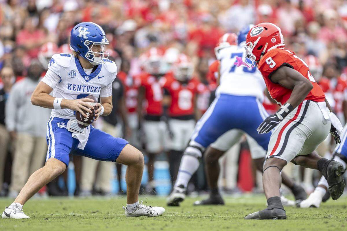 Kentucky Wildcats quarterback Cutter Boley (8) is pressured by Georgia Bulldogs linebacker Chris Cole (9) during a game at Sanford Stadium in Athens, Ga., on Saturday, Oct. 4, 2025. 