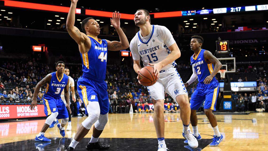 Kentucky forward Isaac Humphries (15) takes aim against Hofstra center Andre Walker (44) as Hofstra guard Justin Wright-Foreman (3) and guard Deron Powers (2) await the rebound in the second half of an NCAA college basketball game, Sunday, Dec. 11, 2016, in New York.