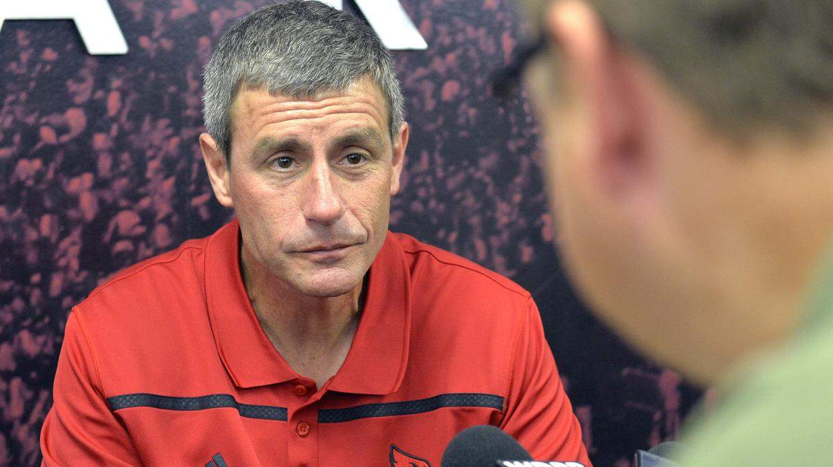 Louisville tight ends coach Chris Klenakis has been placed on leave following his arrest Sunday on charges of drunken driving and wanton endangerment.