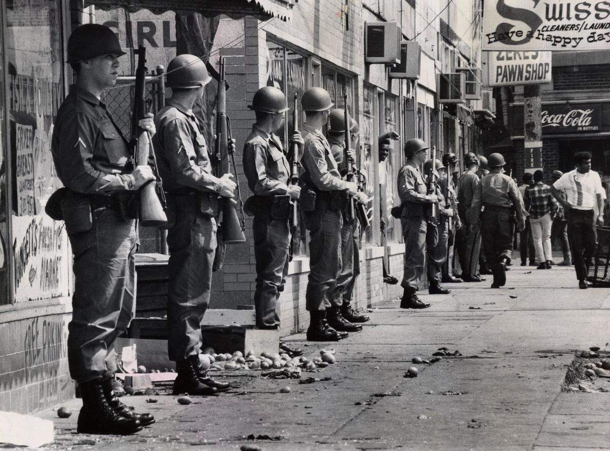 May 28, 1968; Louisville, KY, USA; National Guardsmen stand with rifles ready in front of looted stores on the east side of 28th Street between Dumesnil and Virginia. About a dozen West End stores were broken into on May 28, 1968.  Mandatory Credit: Rovert Steinau/Courier-Journal-USA TODAY NETWORK