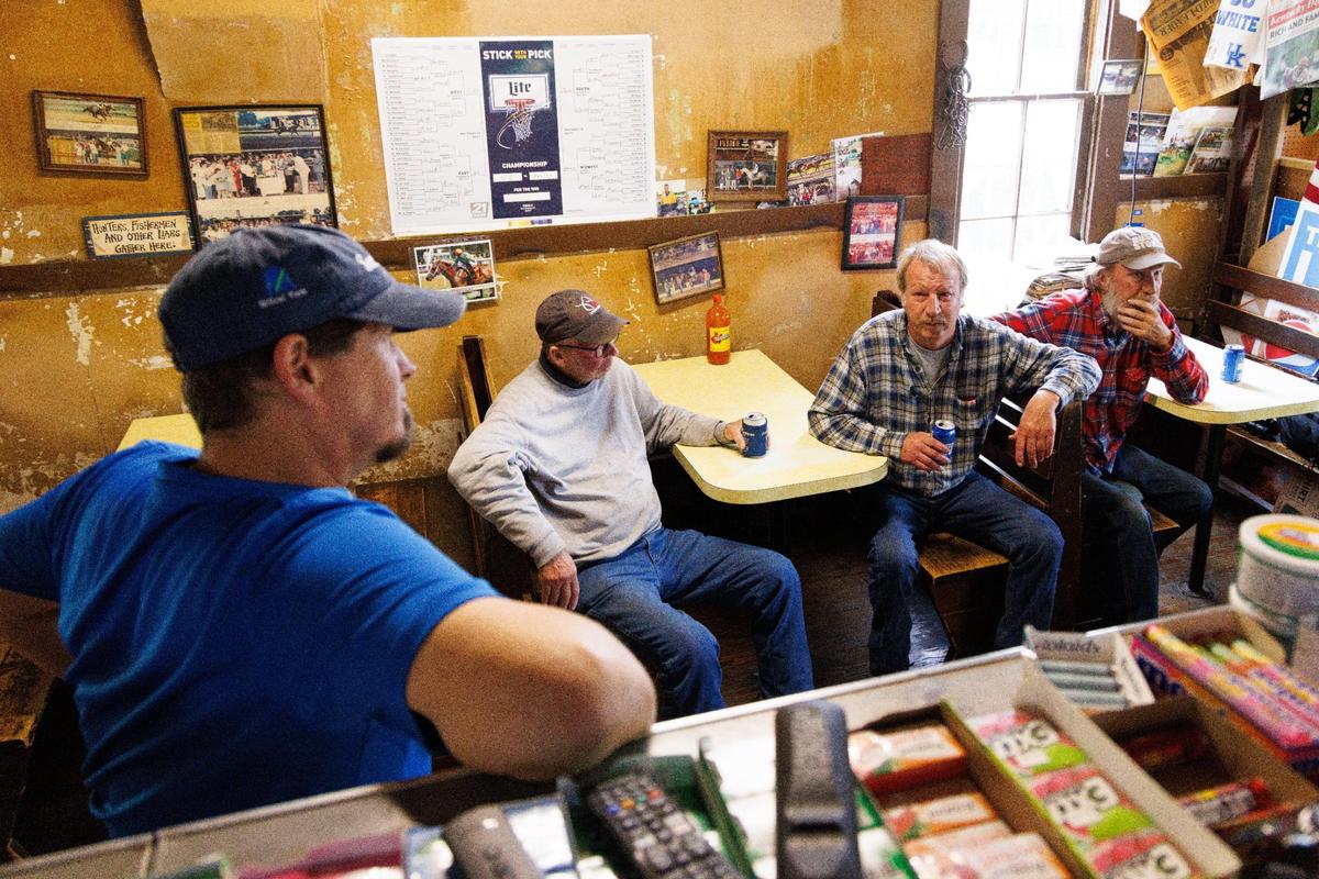 Owner Robey Terrell, left, chats with Ray Hutchens, center left, and Ray Dotson, center, on Friday, May 27, 2022, at the Jot ’em Down Store in Lexington. Hutchens, 56, has been coming to the convince store since he was 3-years-old. Dotson has been a patron for 30 years and watched owner Terrell grow up.
